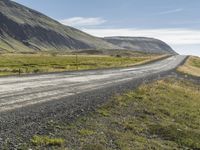 Rural Road in Iceland: Surrounded by Vegetation and Grass on a Slope