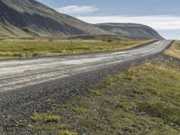 Rural Road in Iceland: Surrounded by Vegetation and Grass on a Slope