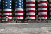 an assortment of large red and white columns with stars and stripes in the background,