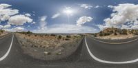 an asphalt road and a sky with clouds in the background as seen through google's viewfinders