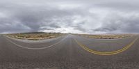 a panorama photograph with several arrows on the road and a stop sign in the middle