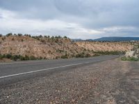 Rural Road in Utah: Scenic Mountains and Clouds