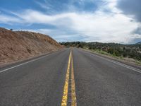 Rural Road in Utah: A Straight Path Through Majestic Mountains