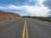 Rural Road in Utah: A Straight Path Through Majestic Mountains