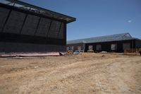 Rural Road with Wooden House Under Clear Sky