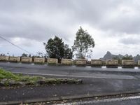 the road is empty in front of the fence, but no cars on it or with a motorhomocry