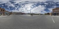 a view of a street from outside with a 360 - lens view of the city and intersection