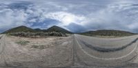 two different perspective photographs of an empty road with a mountain in the background and clouds above