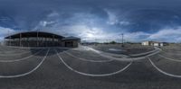 the view of a large empty parking lot from the side on a cloudy day in an open air port