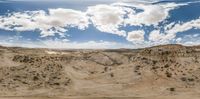 the desert and the sky are clearly visible with clouds overhead in this time lapse view