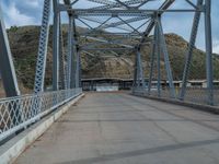 Rural Utah: A Road Leading to a Majestic Bridge and Mountains