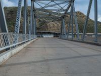 Rural Utah: A Road Leading to a Majestic Bridge and Mountains