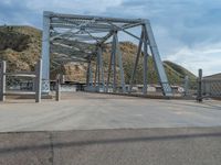 Rural Utah: A Road and Bridge Amidst Mountain and Clouds