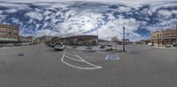 a fish eye view of the outside area in a town center as cars are parked along the side