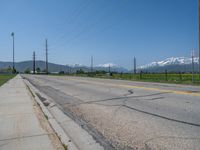 Rural Utah: A Snow-Covered Road Amidst a Majestic Mountain Landscape