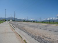 Rural Utah: A Snow-Covered Road Amidst a Majestic Mountain Landscape