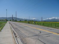 Rural Utah: A Snow-Covered Road Amidst a Majestic Mountain Landscape