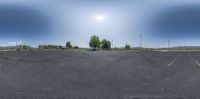 the parking lot has been paved with asphalt and blue skies above the mountain range behind