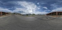 the camera pano shot of a road in front of a stop sign on a corner