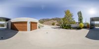 skateboarders ride around in the parking lot at this large house with a modern structure