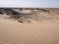 a truck on a dirt road in the desert with rocks and stones on the ground