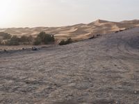 a truck on a dirt road in the desert with rocks and stones on the ground