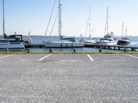 boats are parked on the shore of the harbor on an empty day next to their dock