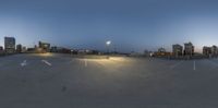 empty parking lot with skyline in the background at night time of 4 15pm pm