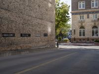 there are several buildings near the street corner in the city, and two are brick