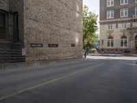 there are several buildings near the street corner in the city, and two are brick