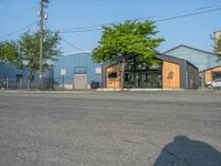 a yellow fire hydrant next to a fence and building with a large number 22 on it