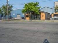 a yellow fire hydrant next to a fence and building with a large number 22 on it