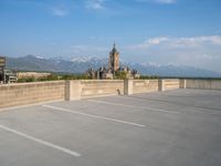 several large empty parking spaces in the city with buildings nearby in front of them -