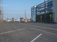 an empty street in front of a large red brick building on the other side of the road is a street light that has a line for motorists