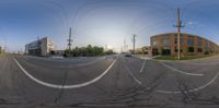 a panorama mirror with multiple images of buildings in the background and some wires hanging over the road