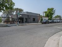 a store on the corner in a small town that has lots of gray brick walls