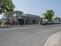 a store on the corner in a small town that has lots of gray brick walls