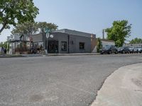 a store on the corner in a small town that has lots of gray brick walls