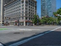 an intersection with buildings on both sides and a street light in the middle of the road