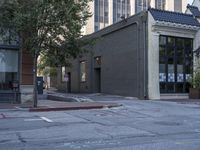 the street in front of a building is marked with graffiti as cars pass by on the side walk