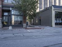 the street in front of a building is marked with graffiti as cars pass by on the side walk