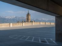 several large empty parking spaces in the city with buildings nearby in front of them -