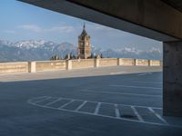 several large empty parking spaces in the city with buildings nearby in front of them -