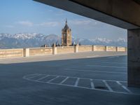 several large empty parking spaces in the city with buildings nearby in front of them -