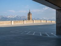 several large empty parking spaces in the city with buildings nearby in front of them -