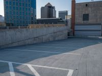 several large empty parking spaces in the city with buildings nearby in front of them -