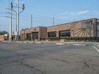 the empty street outside of the business district is empty and deserted with vehicles parked in it