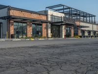 the empty street outside of the business district is empty and deserted with vehicles parked in it