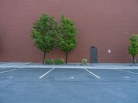 a paved street has been painted light gray, with gray brick walls and concrete edges