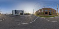 a view from a fish eye lens of a city intersection at sunset, with a van on the corner and a truck on the right